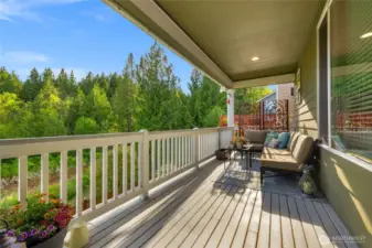 Lovely covered back deck, with views of the greenbelt area