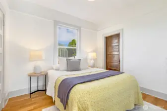 Main floor bedroom with hardwood floors.