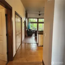 Hallway past entry - second bedroom to the left, second full bathroom to the right, then utility closet to the left, and kitchen to the right.