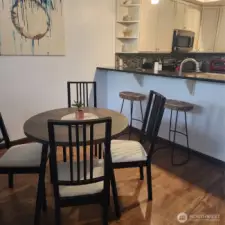Dining area between living room and ktichen eating bar.