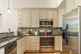 Stylish tiled backsplash continues behind the oven/range.