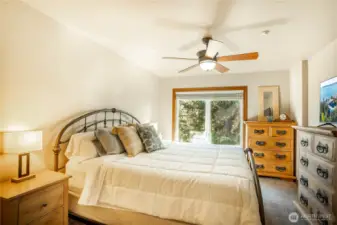 Primary bedroom is roomy.  Great window here into the midst of the trees.