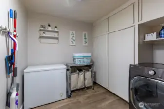 Another view of the laundry room with lots of storage.