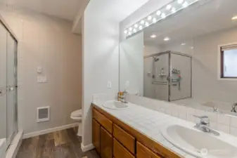 Another view of the primary bath with a dual sink vanity.