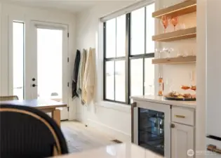 The Bar: Accent lit open shelving, quartz counter tops, Cafe® Bevy Fridge with LED backlighting, Cafe® coffee maker.