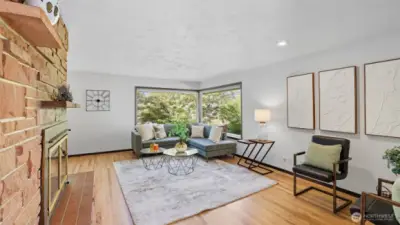 Expansive corner windows fill the living space with natural light and lush greenery views.