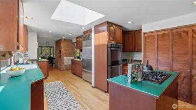 Enjoy a kitchen equipped with a high-end Sub-Zero refrigerator and double ovens.