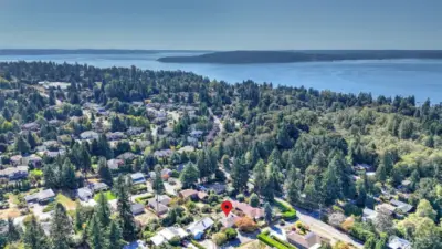 Scenic aerial view highlighting the home’s prime location near the Sound and surrounded by lush greenery.