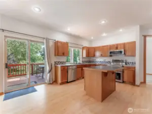 Kitchen with Island Bar and Eating Area that Walks out to the Covered Deck