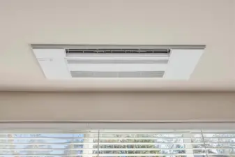 Sleek ceiling-mounted top of the line mini-split system for heating and cooling