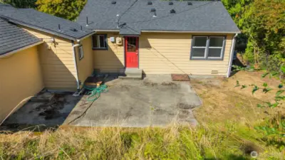 Private back yard and red door to kitchen