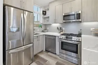 Functional kitchen layout with ample storage, open shelving, and clean modern aesthetic.