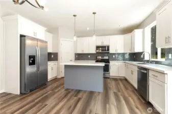 Gas range -Room for  casual eating spaces on Island. Quartz countertops, all stainless appliances.