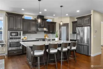 Large open concept kitchen with granite counters, ss appliances and more.