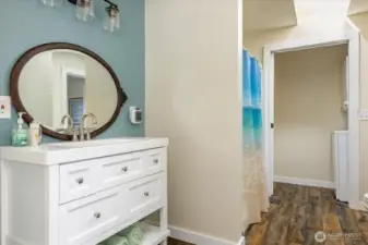 Vanity and shower, looking towards laundry.