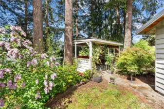Hangout area and gorgeous mature landscaping