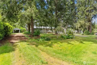 Long side driveway leads to the single garage and the shop. So much parking!