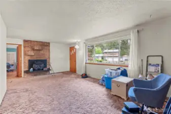 Original/main living room off the entrance with wood burning fireplace