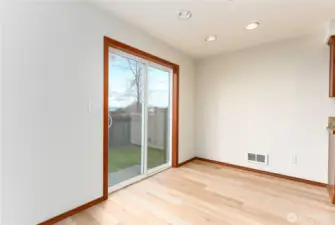 dining room with sliding door to back patio and fully fenced back yard