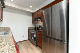 stone tile countertops, new flooring and brand new refrigerator, oven and dishwasher