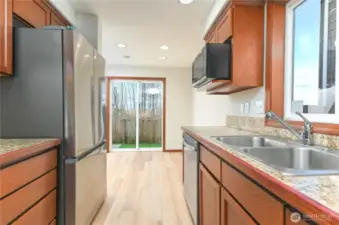 stone tile countertops, new flooring and brand new refrigerator, oven and dishwasher