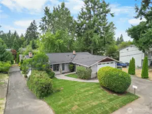 Charming Finn Hill daylight rambler with expansive front yard with mature landscaping.