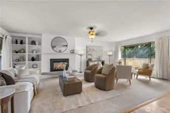 Bright and inviting living room with custom built-ins and garden views.