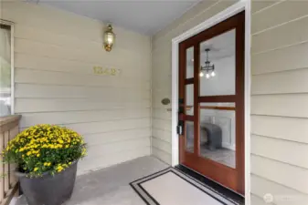 A covered front porch protects you from the elements and beckons you inside.