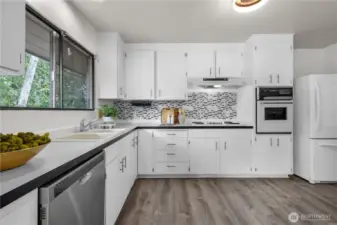 Light and bright kitchen design with backyard views.