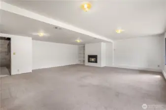 Spacious rec room with fireplace.