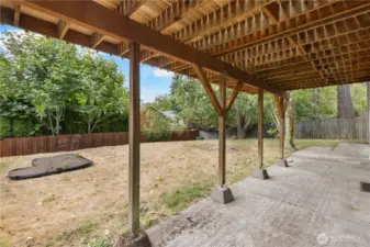 Large backyard with covered patio.