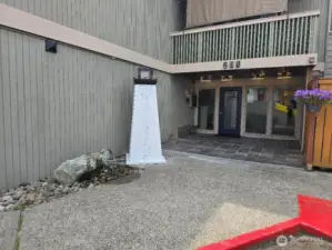 Custom built lighthouse sign and rock water feature at entrance of the building