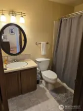Bathrooms have a full set of towels, rug and shower curtains.