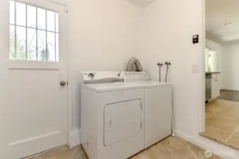 laundry room with man door leading outside