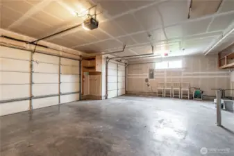 3-car garage with plenty of room for vehicles, shop, and recreational toys.