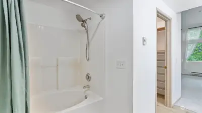 This ensuite also offers a soaking tub and separate water closet behind the photographer.