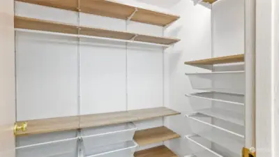 Primary walk-in closet set with custom built-ins for all your cloths, shoes & accessories!