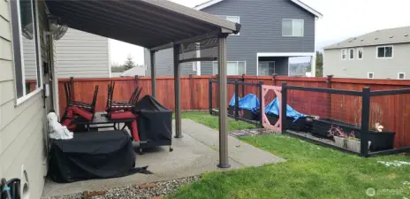 Another View of the Nice Backyard Showing the Entertaining Covered Patio and raised Garden Area.