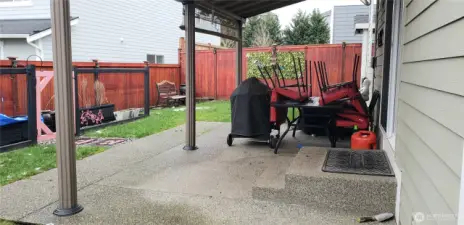 Opposite View of the Nice Backyard Showing the Entertaining Covered Patio and raised Garden Area.