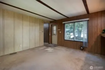 Front door into living room and door into primary bedroom.