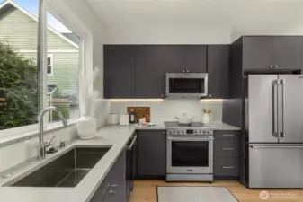 The kitchen is designed for both culinary creativity and daily ease. Photos are of model home with similar fixtures & finishes.