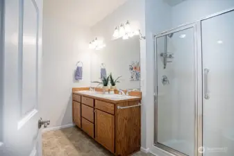 Bath off of primary bedroom 1 with double sinks and shower