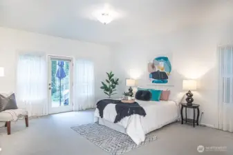 Primary bedroom 2 with door to back deck and lots of natural light