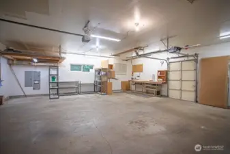 Oversized garage with door to storage shed.
