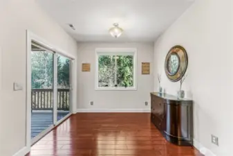 Dining with access to outdoor living on covered deck.