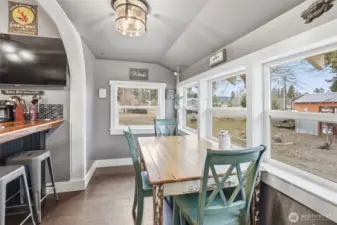 Next to the adorable kitchen is a delightful dining area with HUGE windows for natural light.