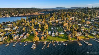 . Set on an expansive two-thirds of an acre lot with 62 feet of waterfront, this property offers front-row seats to golden sunsets over Lake Washington and the Olympic Mountains.