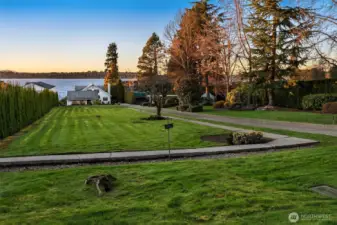 . A lush level lawn stretches to the shoreline, creating an idyllic setting for summer gatherings, lawn games, and easy access to your private dock for boating adventures.