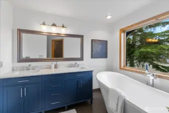 Primary bathroom with dual vanity and modern finishes