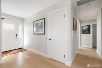 Primary residence entry showing hall to secondary bedrooms, bath and laundry.